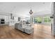 Open concept living room with hardwood floors, modern lighting, and access to outdoor patio at 4359 Prairie Falcon Dr, Zionsville, IN 46077