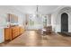 Bright living room with hardwood floors, modern chandelier, and archway to dining area at 4359 Prairie Falcon Dr, Zionsville, IN 46077