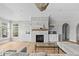 Bright living room features a stone fireplace, custom built-ins, and large windows for ample natural light at 4359 Prairie Falcon Dr, Zionsville, IN 46077