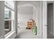 Bright room with arched doorway, plush carpet, and backyard window view at 4359 Prairie Falcon Dr, Zionsville, IN 46077