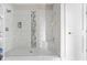 Beautifully tiled walk-in shower with a built-in bench and glass enclosure at 4359 Prairie Falcon Dr, Zionsville, IN 46077