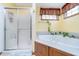 Relaxing bathroom with a walk-in shower, a jacuzzi tub and a window with decorative curtains at 4399 Summerhaven Dr, New Palestine, IN 46163