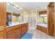 Bright bathroom boasts double sinks, tile flooring, a glass door shower, and a large soaking tub at 4399 Summerhaven Dr, New Palestine, IN 46163