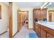 Spacious bathroom offers double sinks, tile floor, and easy access to other rooms in the home at 4399 Summerhaven Dr, New Palestine, IN 46163