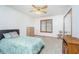 Simple bedroom featuring carpet flooring, a ceiling fan, a window with blinders and a bed with decorative pillows at 4399 Summerhaven Dr, New Palestine, IN 46163