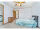 Cozy bedroom with carpet flooring, a ceiling fan, a window with blinders and decorative pillows on the bed at 4399 Summerhaven Dr, New Palestine, IN 46163