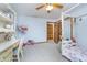 Cozy bedroom featuring carpet, a ceiling fan, a window with blinders, and a decorative desk at 4399 Summerhaven Dr, New Palestine, IN 46163