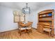 Cozy dining nook with wood table and chairs, adjacent hutch, and natural light streaming in through the window at 4399 Summerhaven Dr, New Palestine, IN 46163
