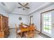Cozy dining room with tray ceilings, classic wood furniture, neutral decor, and natural light at 4399 Summerhaven Dr, New Palestine, IN 46163