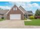 Charming brick home with a two-car garage, a cozy front porch, and well-manicured landscaping at 4399 Summerhaven Dr, New Palestine, IN 46163