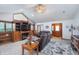 Bright living room with a vaulted ceiling, fireplace, and built-in shelving, plus comfortable seating and a rug at 4399 Summerhaven Dr, New Palestine, IN 46163