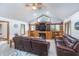 Inviting living room with vaulted ceilings, a fireplace, custom built-ins, and comfortable leather seating at 4399 Summerhaven Dr, New Palestine, IN 46163