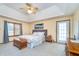 Spacious main bedroom featuring a tray ceiling, a ceiling fan, carpeted floor and a door to outside at 4399 Summerhaven Dr, New Palestine, IN 46163