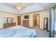 Open main bedroom boasts a ceiling fan, carpeted floors, and natural light from the window at 4399 Summerhaven Dr, New Palestine, IN 46163