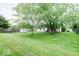 Expansive backyard with mature trees, shed, and distant home view at 444 Austin Dr, Avon, IN 46123