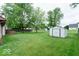 Large backyard featuring a well-kept lawn and a storage shed at 444 Austin Dr, Avon, IN 46123