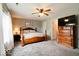 A cozy bedroom with plush carpets, a ceiling fan, and a large wooden dresser at 444 Austin Dr, Avon, IN 46123