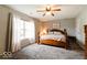 Comfortable bedroom featuring a wooden bed frame, ceiling fan, and neutral decor at 444 Austin Dr, Avon, IN 46123