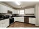 Functional kitchen with stainless steel appliances, modern white cabinets, and black countertops at 444 Austin Dr, Avon, IN 46123