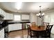 Eat-in kitchen featuring stainless appliances, white cabinetry and black marble countertops at 444 Austin Dr, Avon, IN 46123