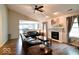 Inviting living room with vaulted ceiling, fan, fireplace, wood floors and lots of natural light at 444 Austin Dr, Avon, IN 46123