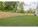 Large, fenced backyard with lush green grass, perfect for outdoor activities and privacy at 4477 Devon Lake Rd, Indianapolis, IN 46226