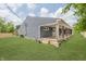Spacious backyard with a beautiful gray home and a large wooden porch, ideal for outdoor living at 4477 Devon Lake Rd, Indianapolis, IN 46226