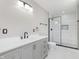 Modern bathroom with walk-in shower, sleek vanity, and tiled floor at 4477 Devon Lake Rd, Indianapolis, IN 46226