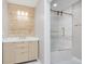 Bathroom with blonde wood accent wall behind vanity and white shower with sliding glass door at 4477 Devon Lake Rd, Indianapolis, IN 46226