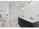 Bright bathroom with marble floors, dual sink vanity with white countertop, and modern lighting fixtures at 4477 Devon Lake Rd, Indianapolis, IN 46226