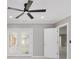 Bright room with double doors to back deck and closet doors, ceiling fan, and neutral paint at 4477 Devon Lake Rd, Indianapolis, IN 46226