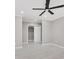 Simple bedroom with a ceiling fan, a sliding door closet, light wood flooring, and white trim at 4477 Devon Lake Rd, Indianapolis, IN 46226