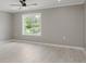 Neutral bedroom with light wood floors, a large window, and neutral walls with white trim at 4477 Devon Lake Rd, Indianapolis, IN 46226