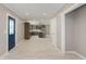 Bright, open-concept entryway reveals a modern kitchen, neutral walls, wood-look floors, and a blue front door at 4477 Devon Lake Rd, Indianapolis, IN 46226
