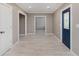 Bright entryway features wood-look tile floors, neutral walls, and a blue front door with decorative glass inserts at 4477 Devon Lake Rd, Indianapolis, IN 46226
