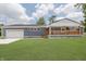 Charming single-story home features a well-maintained lawn, garage, and covered porch with attractive wooden railings at 4477 Devon Lake Rd, Indianapolis, IN 46226