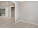 Hallway features neutral walls, white trim, and wood-look tile floors, seamlessly connecting the home's living spaces at 4477 Devon Lake Rd, Indianapolis, IN 46226