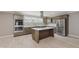 Spacious kitchen features stainless steel appliances, granite countertops, backsplash, and a stylish island with cooktop at 4477 Devon Lake Rd, Indianapolis, IN 46226