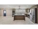 Open-concept kitchen features stainless appliances, granite countertops, stylish backsplash, and a modern island cooktop at 4477 Devon Lake Rd, Indianapolis, IN 46226