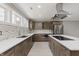 Modern kitchen features quartz countertops, stainless appliances, island cooktop, tiled backsplash, and ample storage at 4477 Devon Lake Rd, Indianapolis, IN 46226