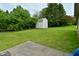 A backyard featuring a storage shed and lush green lawn at 4528 Hunt Master Ct, Indianapolis, IN 46268