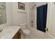 Bathroom features a white toilet, shower with blue curtain, and wooden framed art at 4528 Hunt Master Ct, Indianapolis, IN 46268