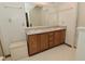 Bathroom vanity with double sinks, wood cabinetry and gray and white countertop at 4528 Hunt Master Ct, Indianapolis, IN 46268