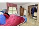 Comfortable bedroom with a closet rack, wardrobe, and a window with a pink valance at 4528 Hunt Master Ct, Indianapolis, IN 46268