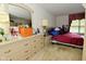 View of a bedroom showcasing a dresser with decorations, with a visible bed in the background at 4528 Hunt Master Ct, Indianapolis, IN 46268