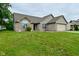 Well-maintained one-story home with green grass and a two-car garage, perfect for suburban living at 4528 Hunt Master Ct, Indianapolis, IN 46268