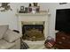 Elegant white fireplace with a decorative screen and mantle decor at 4528 Hunt Master Ct, Indianapolis, IN 46268
