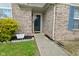Inviting front entrance with a brick facade, walkway, manicured shrubs, and a storm door at 4528 Hunt Master Ct, Indianapolis, IN 46268