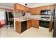 Traditional kitchen features wood cabinets, black appliances, and light countertops at 4528 Hunt Master Ct, Indianapolis, IN 46268