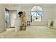 Inviting living room with a vaulted ceiling, a large arched window, and neutral carpeting at 4528 Hunt Master Ct, Indianapolis, IN 46268